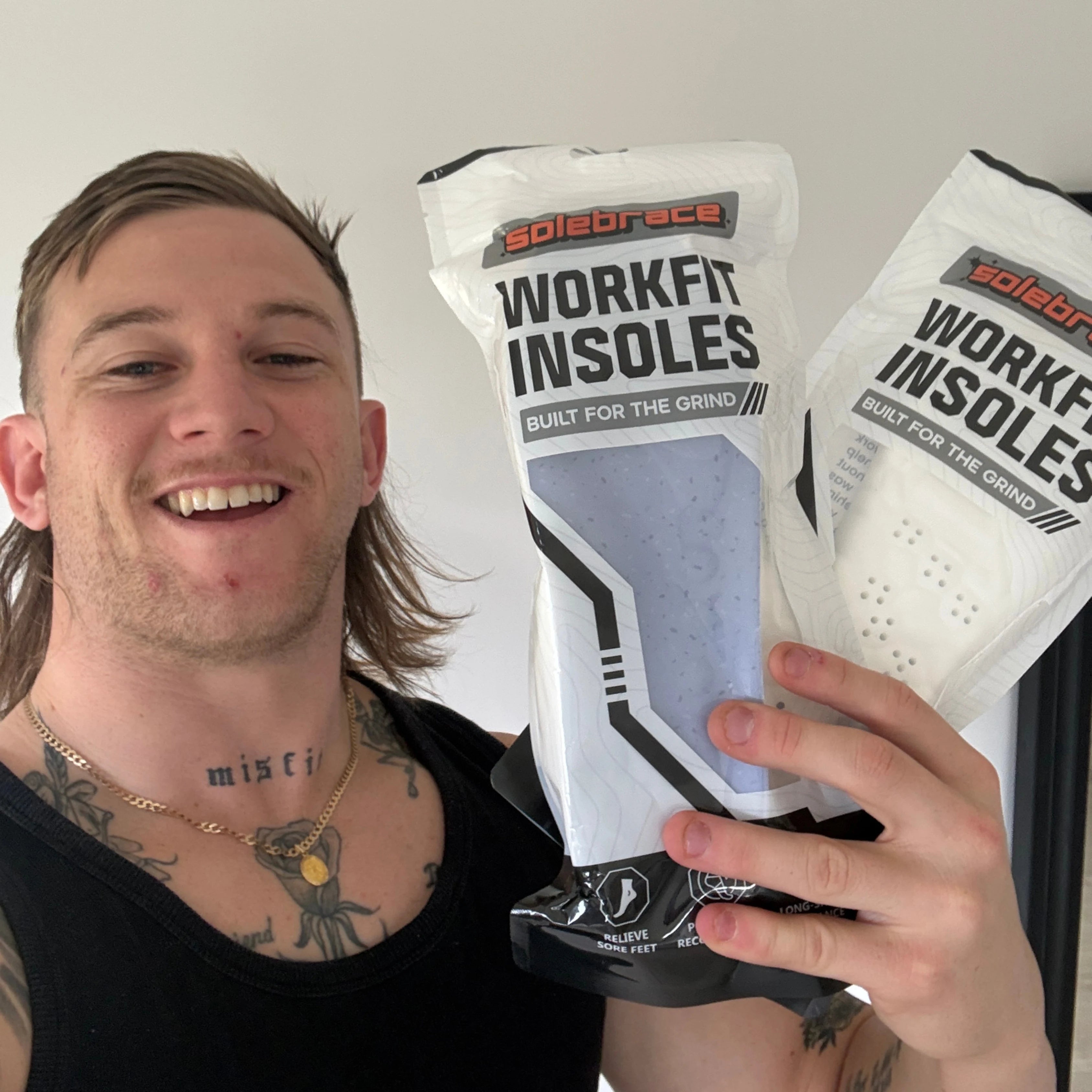 WorkFit customer holding SoleBrace WorkFit Insoles