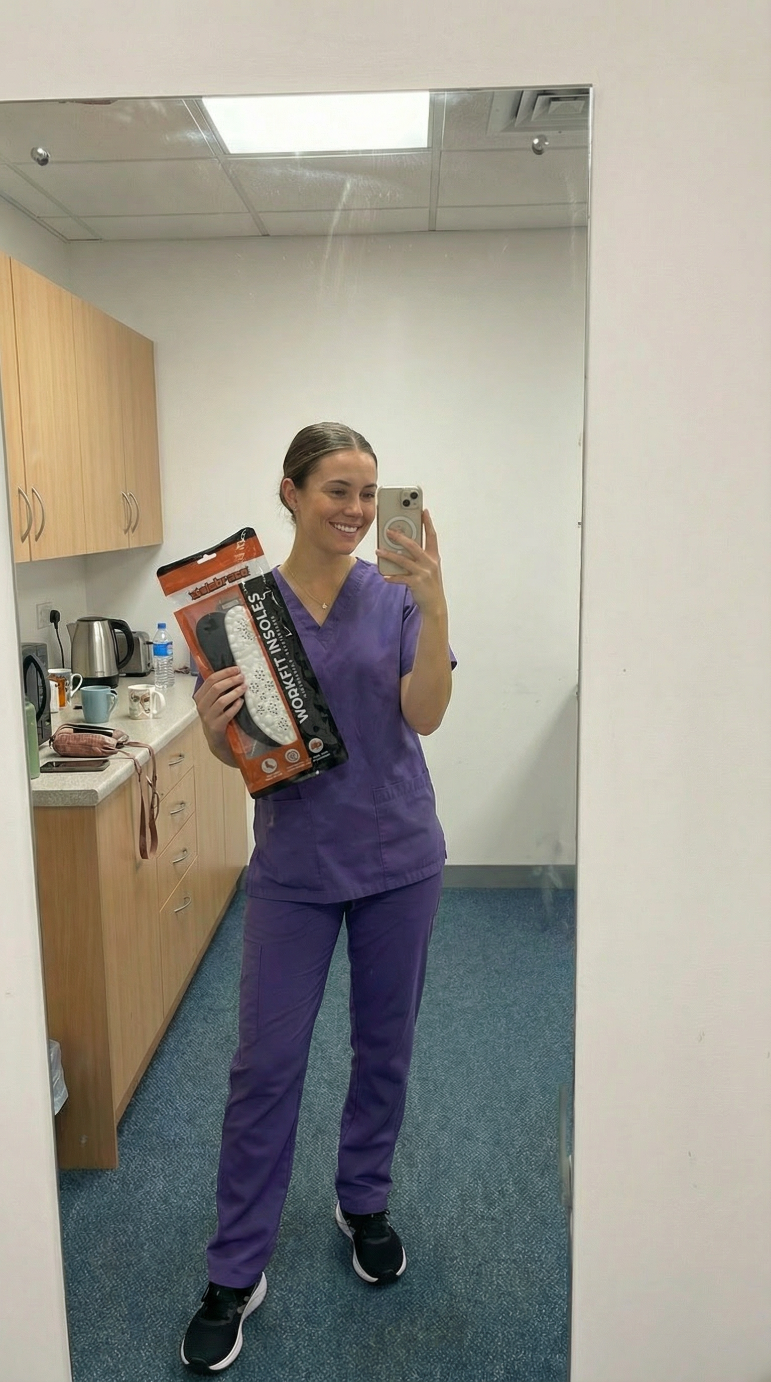 Healthcare worker in scrubs with WorkFit Insoles